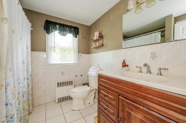 20 Wainwright St, Ronkonkoma, NY 11779 - bathroom with radiator, vanity, tile walls, tile patterned flooring, and wainscoting