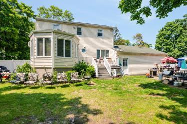 20 Wainwright St, Ronkonkoma, NY 11779 - rear view of house featuring a wooden deck and stairway