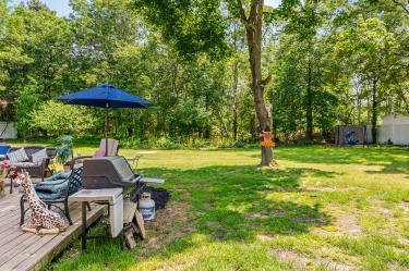 20 Wainwright St, Ronkonkoma, NY 11779 - view of grassy yard featuring a wooden deck