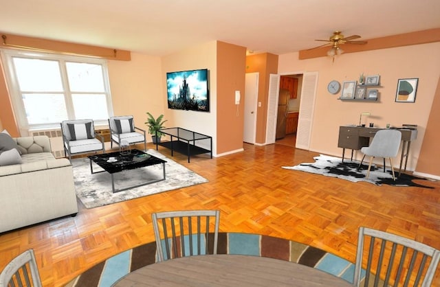 281 Garth Rd Unit B5D, Scarsdale, NY 10583 - living area featuring baseboards and a ceiling fan
