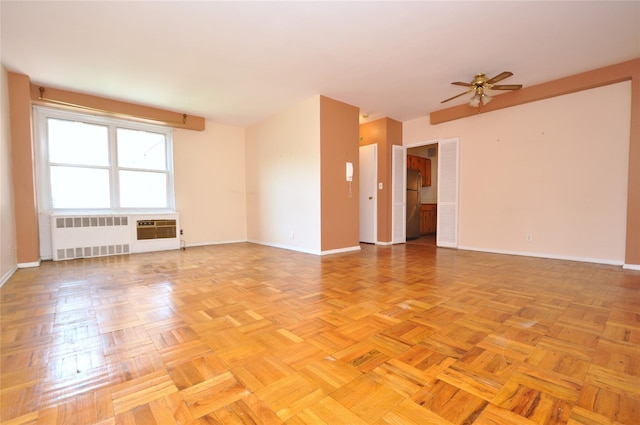 281 Garth Rd Unit B5D, Scarsdale, NY 10583 - unfurnished room featuring radiator, ceiling fan, and a wall mounted air conditioner