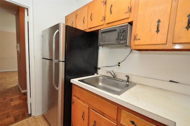 281 Garth Rd Unit B5D, Scarsdale, NY 10583 - kitchen featuring black microwave, freestanding refrigerator, and light countertops