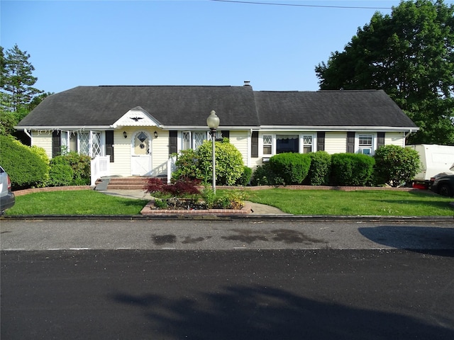 524 Polaris St, North Babylon, NY 11703 - new england style home featuring a front lawn