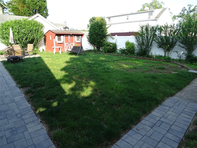 524 Polaris St, North Babylon, NY 11703 - view of yard featuring a storage unit and a fire pit