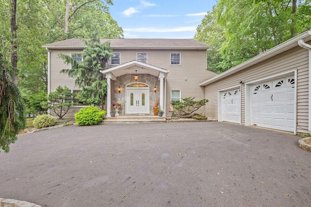 17 Dunmore Rd, New City, NY 10956 - view of front of house with driveway, stone siding, and a garage