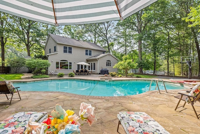 17 Dunmore Rd, New City, NY 10956 - view of swimming pool featuring a patio, a fenced backyard, view of scattered trees, and a grill