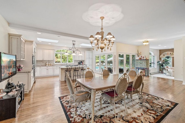 17 Dunmore Rd, New City, NY 10956 - dining room with a chandelier, light wood-type flooring, recessed lighting, and a skylight