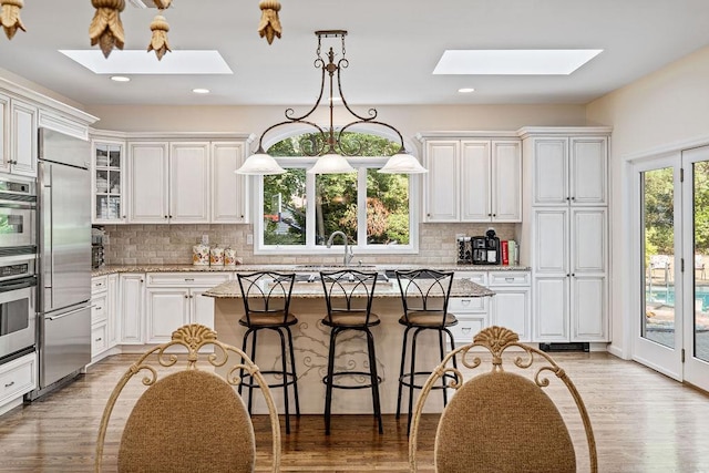 17 Dunmore Rd, New City, NY 10956 - kitchen with a skylight, stainless steel appliances, a center island, tasteful backsplash, and recessed lighting