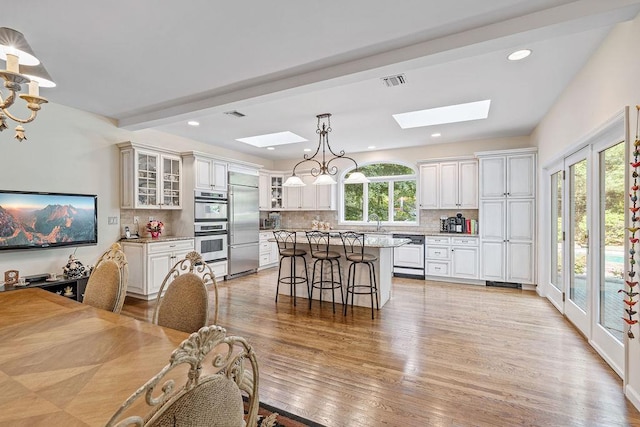17 Dunmore Rd, New City, NY 10956 - dining space with a skylight, light wood-style flooring, recessed lighting, and a chandelier