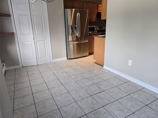 36 Hampton Ct, Middletown, NY 10941 - kitchen with stainless steel appliances, light tile patterned flooring, dark countertops, and backsplash
