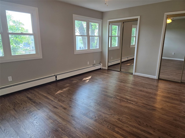 36 Hampton Ct, Middletown, NY 10941 - unfurnished bedroom with a baseboard radiator, wood finished floors, and multiple closets