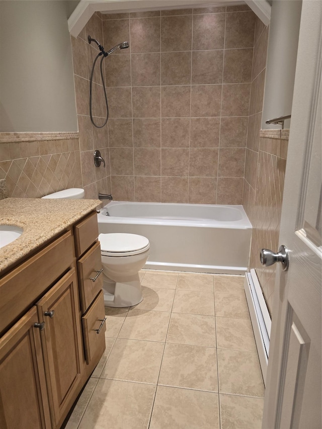 36 Hampton Ct, Middletown, NY 10941 - full bath with a baseboard heating unit, tile walls, vanity, tile patterned floors, and shower / bath combination