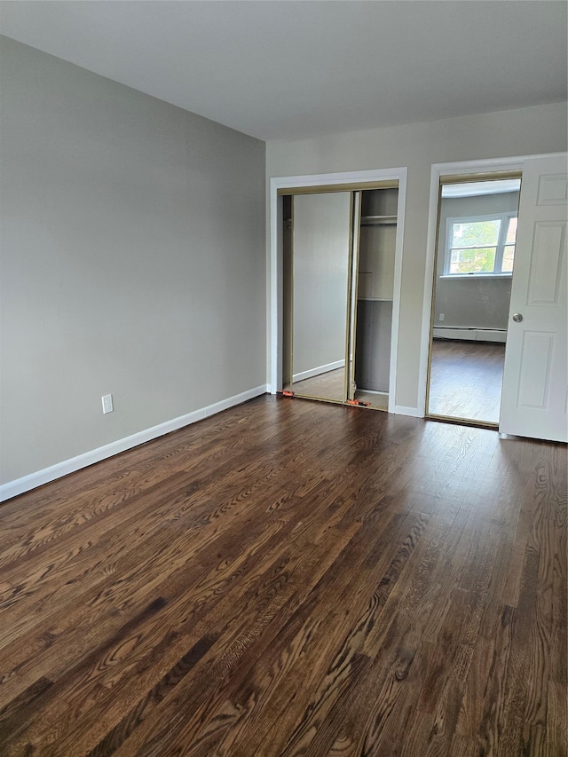 36 Hampton Ct, Middletown, NY 10941 - unfurnished bedroom featuring a baseboard radiator, dark wood-style floors, and a closet