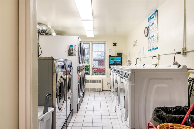 151-05 Cross Island Pkwy Unit 1D, Whitestone, NY 11357 - community laundry room with washer and clothes dryer, light tile patterned floors, and radiator heating unit