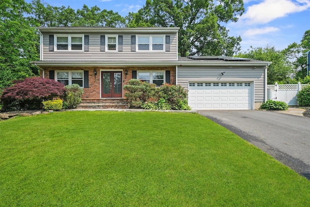 25 Bellwood Dr, New City, NY 10956 - view of front of property featuring french doors, driveway, solar panels, an attached garage, and brick siding