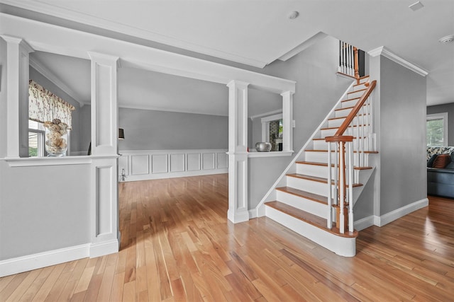 25 Bellwood Dr, New City, NY 10956 - stairway featuring decorative columns, wood finished floors, crown molding, and a wainscoted wall