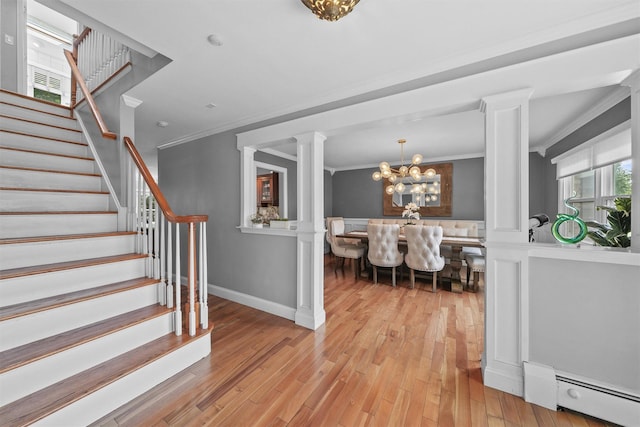 25 Bellwood Dr, New City, NY 10956 - foyer entrance featuring a baseboard radiator, ornamental molding, stairway, a chandelier, and light wood-type flooring
