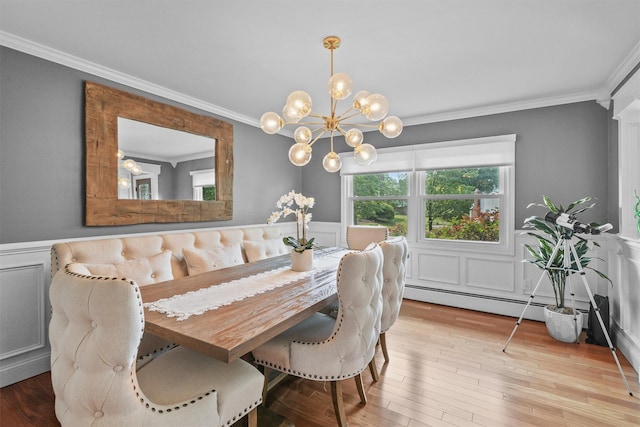 25 Bellwood Dr, New City, NY 10956 - dining area featuring ornamental molding, wainscoting, wood finished floors, a chandelier, and baseboard heating
