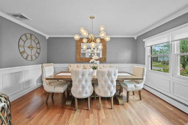 25 Bellwood Dr, New City, NY 10956 - dining area featuring baseboard heating, crown molding, a chandelier, wainscoting, and light wood-style flooring