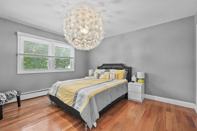 25 Bellwood Dr, New City, NY 10956 - bedroom with hardwood / wood-style floors, a chandelier, and baseboard heating