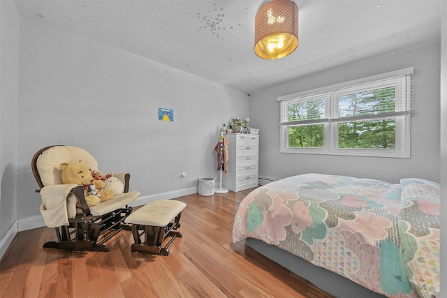 25 Bellwood Dr, New City, NY 10956 - bedroom with wood finished floors and a baseboard heating unit