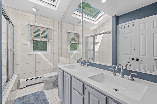 25 Bellwood Dr, New City, NY 10956 - full bath with a skylight, a baseboard heating unit, tile walls, tile patterned flooring, and double vanity