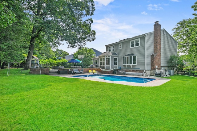 25 Bellwood Dr, New City, NY 10956 - rear view of house with a chimney, a yard, and outdoor lounge area
