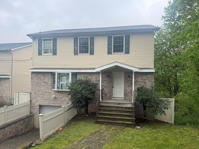 48 Patmore Ave, Yonkers, NY 10710 - colonial home with brick siding, an attached garage, and a front yard