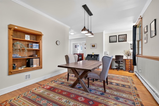 62 Guymard Tpke, Godeffroy, NY 12729 - dining room featuring a baseboard radiator, a desk, ornamental molding, and wood finished floors