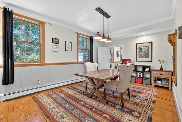 62 Guymard Tpke, Godeffroy, NY 12729 - dining room featuring a baseboard radiator, light wood finished floors, crown molding, and wainscoting