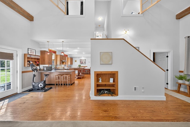 62 Guymard Tpke, Godeffroy, NY 12729 - living area with a high ceiling, light wood-style floors, stairs, and beam ceiling