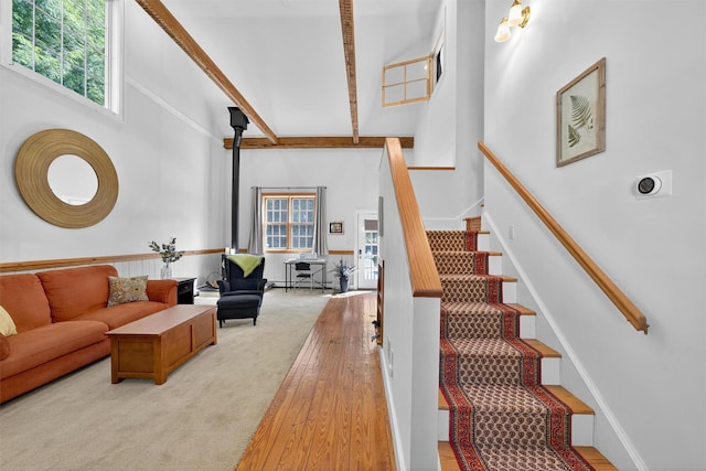 62 Guymard Tpke, Godeffroy, NY 12729 - staircase featuring high vaulted ceiling, a wood stove, beam ceiling, and wood finished floors