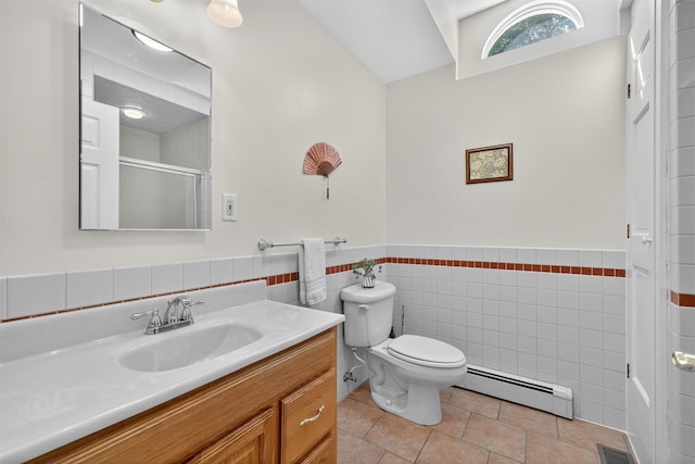 62 Guymard Tpke, Godeffroy, NY 12729 - full bath with baseboard heating, vanity, tile patterned floors, tile walls, and a shower with door