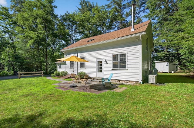 62 Guymard Tpke, Godeffroy, NY 12729 - rear view of property featuring a patio, a yard, and a storage shed