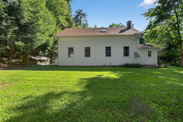 62 Guymard Tpke, Godeffroy, NY 12729 - back of house featuring a chimney, a yard, and roof with shingles