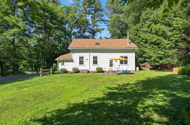 62 Guymard Tpke, Godeffroy, NY 12729 - rear view of property featuring a lawn and a patio area