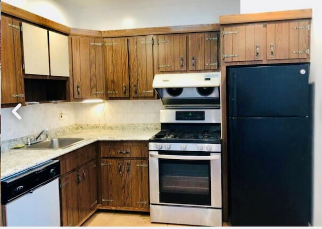 5-39 117th St, Flushing, NY 11356 - kitchen featuring freestanding refrigerator, dishwasher, stainless steel gas range oven, light countertops, and decorative backsplash