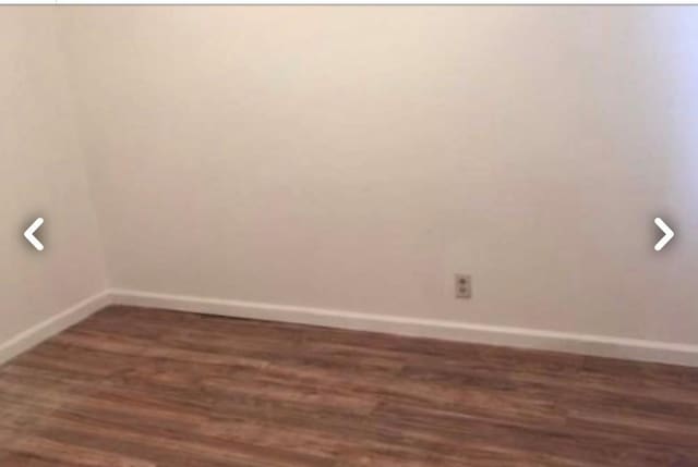 5-39 117th St, Flushing, NY 11356 - unfurnished room with baseboards and dark wood-type flooring