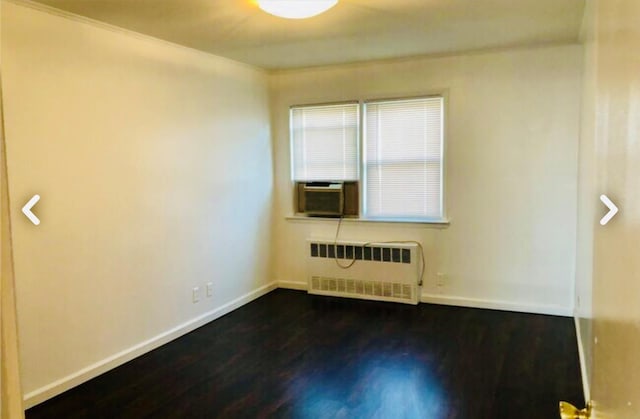 5-39 117th St, Flushing, NY 11356 - spare room with radiator, cooling unit, and dark wood-style floors