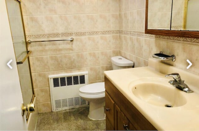 5-39 117th St, Flushing, NY 11356 - full bathroom featuring radiator, vanity, a shower, and tile walls