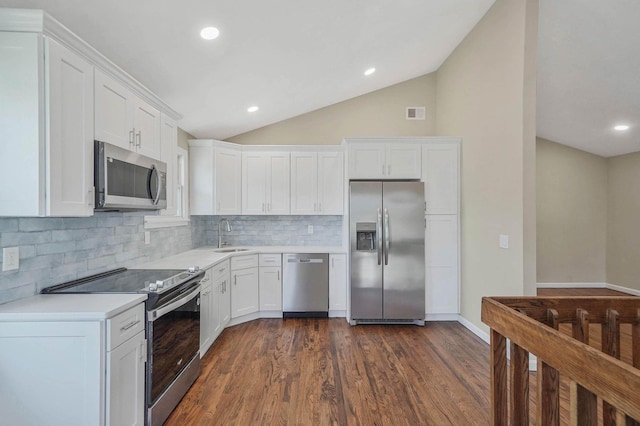 12 Bay Ave, Lake Ronkonkoma, NY 11779 - kitchen with stainless steel appliances, decorative backsplash, lofted ceiling, light countertops, and white cabinetry