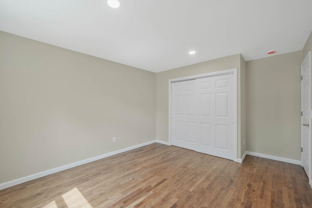 12 Bay Ave, Lake Ronkonkoma, NY 11779 - unfurnished bedroom with wood finished floors, a closet, and recessed lighting