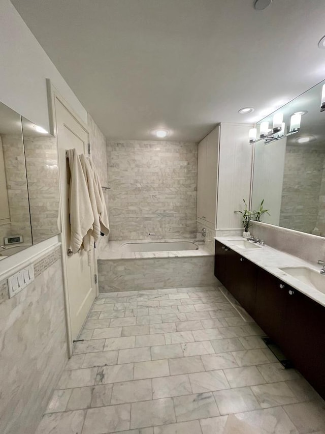 5 Renaissance Sq Unit Ph6C, White Plains, NY 10601 - bathroom with a garden tub, double vanity, marble look tiles, and recessed lighting