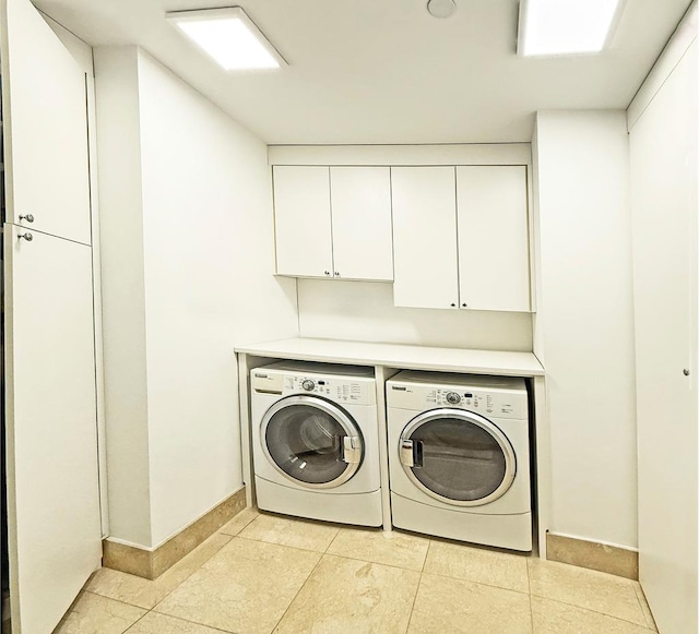 5 Renaissance Sq Unit Ph6C, White Plains, NY 10601 - laundry area featuring independent washer and dryer, cabinet space, and light tile patterned floors