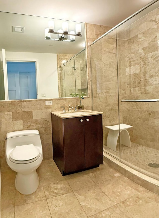 5 Renaissance Sq Unit Ph6C, White Plains, NY 10601 - bathroom featuring tile walls, a stall shower, vanity, and tile patterned flooring