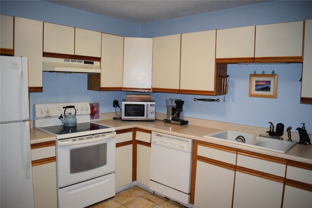 3905 Wild Berry Ct Unit 6C, Poughkeepsie, NY 12603 - kitchen with white appliances, under cabinet range hood, light countertops, light tile patterned floors, and a textured ceiling