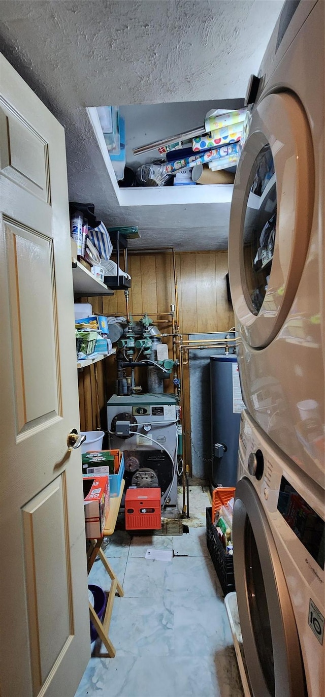 76 Gooseberry Rd, Mastic Beach, NY 11951 - washroom with stacked washer / dryer, water heater, and a textured ceiling