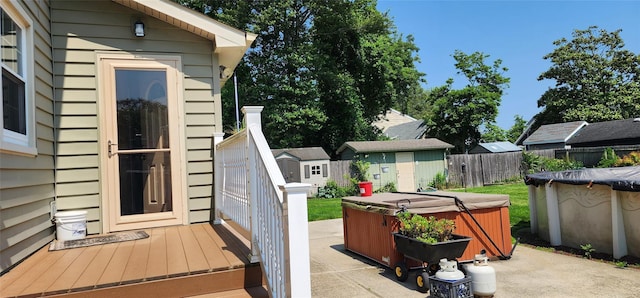 76 Gooseberry Rd, Mastic Beach, NY 11951 - view of patio featuring a hot tub and a storage unit