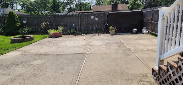 76 Gooseberry Rd, Mastic Beach, NY 11951 - fenced backyard featuring a fire pit and a patio