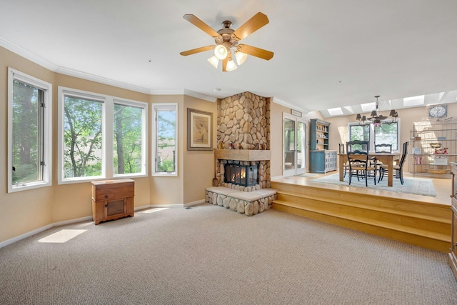 76 Boulder Ridge Rd, Scarsdale, NY 10583 - carpeted living area featuring ornamental molding, healthy amount of natural light, a ceiling fan, a fireplace, and a skylight